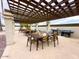 Outdoor kitchen and dining area with pergola, grill, and seating at 205 S Higley Rd # 288, Mesa, AZ 85206