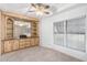 Living room with built-in wooden cabinetry and a ceiling fan at 205 S Higley Rd # 288, Mesa, AZ 85206