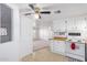 Bright kitchen features white cabinets, wood countertops, and a view into the living room at 205 S Higley Rd # 288, Mesa, AZ 85206