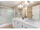 Bathroom features double vanity with white cabinets and a shower/tub combo at 205 S Higley Rd # 288, Mesa, AZ 85206