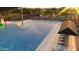 Community pool with lounge chairs and shade structures at 9986 W Cora W Ln, Avondale, AZ 85392