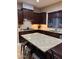 Modern kitchen featuring granite countertops and dark wood cabinetry at 4450 S Rio Dr, Chandler, AZ 85249
