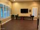 Game room featuring shuffleboard, TV, and plantation shutters at 4450 S Rio Dr, Chandler, AZ 85249