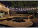Night view of a sparkling pool and spa with string lights at 4450 S Rio Dr, Chandler, AZ 85249