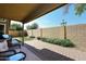 Private backyard with paved patio, grassy area, and block wall at 15626 N 50Th St, Scottsdale, AZ 85254