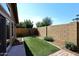 Landscaped backyard with artificial turf and block wall at 15626 N 50Th St, Scottsdale, AZ 85254