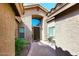Courtyard entry with brick pavers, a dark wooden door and small sitting area at 15626 N 50Th St, Scottsdale, AZ 85254