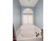 Bathroom featuring a large garden tub and arched window with shutters at 15626 N 50Th St, Scottsdale, AZ 85254