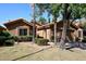 Tan stucco house with tile roof, a two-car garage, and mature landscaping at 15626 N 50Th St, Scottsdale, AZ 85254