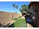 Artificial turf backyard with block wall and patio access at 15626 N 50Th St, Scottsdale, AZ 85254