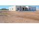 Tan house with tile roof, two-car garage, and desert landscaping at 29408 N 244Th Dr, Wittmann, AZ 85361