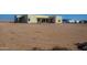 View of the house from the large, empty backyard at 29408 N 244Th Dr, Wittmann, AZ 85361