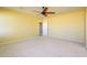 Spacious bedroom with neutral walls, ceiling fan and carpeted floor at 29408 N 244Th Dr, Wittmann, AZ 85361