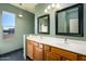Bathroom with double vanity, large mirrors and window at 29408 N 244Th Dr, Wittmann, AZ 85361