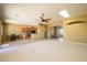 Open living room with tile and carpet flooring, high ceilings, and ceiling fan at 29408 N 244Th Dr, Wittmann, AZ 85361