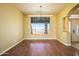Bright dining room with wood floors, a chandelier, and large window at 29408 N 244Th Dr, Wittmann, AZ 85361