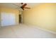 Spacious bedroom with double doors and ceiling fan at 29408 N 244Th Dr, Wittmann, AZ 85361
