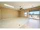 Living room with carpet, ceiling fan, sliding door to patio, and skylight at 29408 N 244Th Dr, Wittmann, AZ 85361