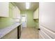 Laundry room with granite countertop, cabinets and a wine cooler at 29408 N 244Th Dr, Wittmann, AZ 85361