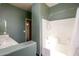 Bathroom with shower/tub combo and a built-in vanity at 29408 N 244Th Dr, Wittmann, AZ 85361