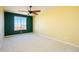 Bright bedroom with large window, ceiling fan and carpet at 29408 N 244Th Dr, Wittmann, AZ 85361