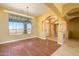 Spacious dining area with hardwood floors, a chandelier, and views of the entryway at 29408 N 244Th Dr, Wittmann, AZ 85361