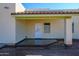 Small back patio with a door and window at 29408 N 244Th Dr, Wittmann, AZ 85361