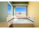 Bathroom with a large soaking tub and a window overlooking the desert at 29408 N 244Th Dr, Wittmann, AZ 85361