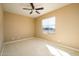 Well-lit bedroom featuring a ceiling fan and a window with blinds at 29408 N 244Th Dr, Wittmann, AZ 85361