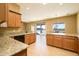 Spacious kitchen with granite countertops and island, open to dining area at 29408 N 244Th Dr, Wittmann, AZ 85361