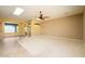 Large living room with carpet, ceiling fan and views into dining area at 29408 N 244Th Dr, Wittmann, AZ 85361
