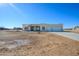 Tan house with tile roof, two-car garage, and desert landscaping at 29408 N 244Th Dr, Wittmann, AZ 85361