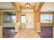 Elegant entryway with wood columns, tiled floors, and a large front door at 29408 N 244Th Dr, Wittmann, AZ 85361