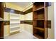 Spacious walk-in closet with built-in shelves and hanging rods at 29408 N 244Th Dr, Wittmann, AZ 85361