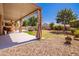 Relaxing backyard oasis with covered patio, pool, and grassy area at 44163 W Palo Abeto Dr, Maricopa, AZ 85138