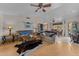 Living room with wood floors, comfortable seating, and view to dining area at 51312 N Mockingbird Trl, Wickenburg, AZ 85390