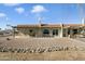 Home with covered patio, gravel landscaping, and rock wall at 11405 S Tawa Ln, Phoenix, AZ 85044