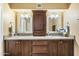 Double vanity bathroom with dark wood cabinets and large mirrors at 11405 S Tawa Ln, Phoenix, AZ 85044