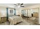 Bright bedroom with mirrored closet doors and wood-look floors at 11405 S Tawa Ln, Phoenix, AZ 85044