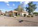 Single-story home with attractive landscaping and a two-car garage at 11405 S Tawa Ln, Phoenix, AZ 85044