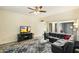 Living room with comfortable seating and a large flat-screen TV at 11405 S Tawa Ln, Phoenix, AZ 85044