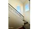 Elegant staircase with wrought iron railing and window at 1318 S Owl Dr, Gilbert, AZ 85296