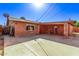 Brick home with a large covered patio and spacious backyard at 3926 W Stella Ln, Phoenix, AZ 85019