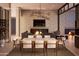 Elegant dining room with a stone fireplace and modern chandelier at 33094 N Northstar Cir, Scottsdale, AZ 85266