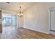 Spacious dining area with wood-look floors and chandelier at 12618 W Bonanza Dr, Sun City West, AZ 85375