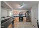 Modern kitchen with stainless steel appliances and light wood cabinets at 44977 W Miraflores St, Maricopa, AZ 85139