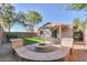 Backyard with fire pit and sitting area at 44977 W Miraflores St, Maricopa, AZ 85139
