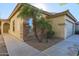 Tan house with a two-car garage and walkway at 44977 W Miraflores St, Maricopa, AZ 85139