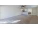 Bright living room with neutral carpet and an open floor plan at 44977 W Miraflores St, Maricopa, AZ 85139