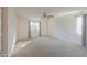 Primary bedroom with ceiling fan and window at 44977 W Miraflores St, Maricopa, AZ 85139